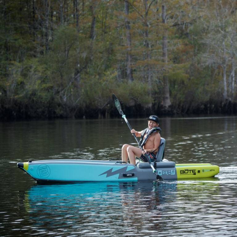 Man paddling the DEUS Aero Native Citron